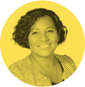 Portrait of a smiling woman with short curly hair wearing a striped top against a yellow circular background.